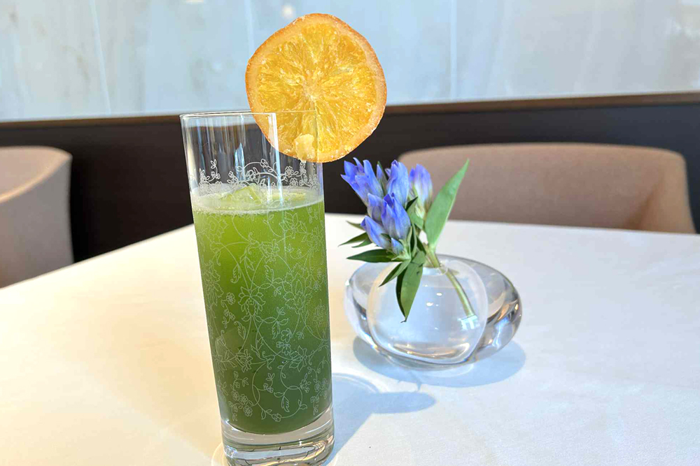紹興酒に抹茶を合わせたベースをソーダで割った‟抹茶紹興酒ハイボール”。カクテルにデコレーションのドライオレンジを混ぜるとさらに味わい深くなり、食前はもちろん食後酒としても同店の料理とよく合う一杯だ